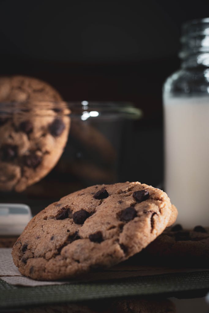 Delicious chocolate chip cookies paired with a glass of milk, perfect for snacking.