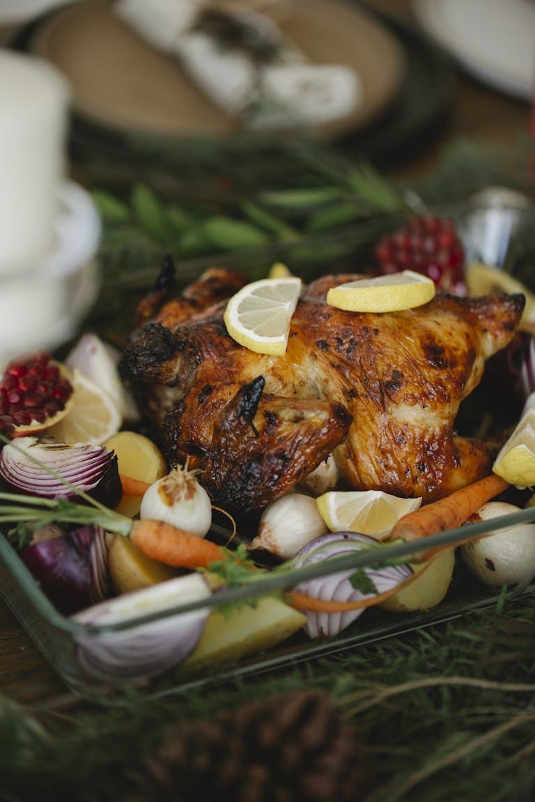 Delicious roast chicken surrounded by fresh vegetables, perfect for a holiday feast.