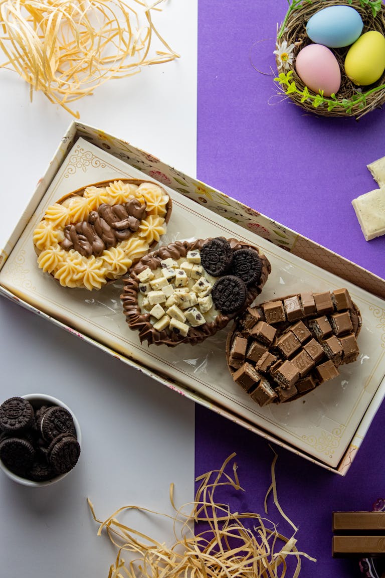 Vibrant mix of chocolate eggs with cookies and candy toppings, perfect for Easter celebrations.